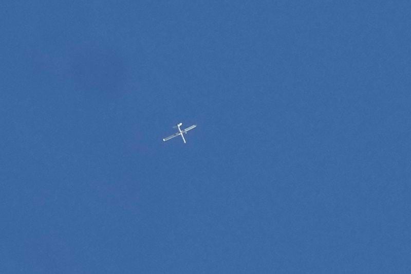 FILE - An Israeli reconnaissance drone flies over the funeral procession of four Hezbollah fighters who were killed Tuesday after their handheld devices exploded in the southern suburb of Beirut, Wednesday, Sept. 18, 2024. (AP Photo/Bilal Hussein, File)