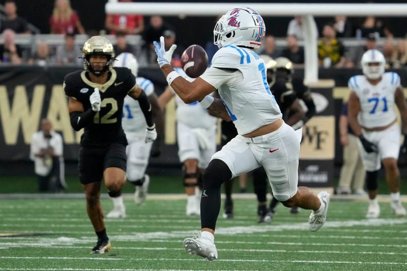 Mississippi wide receiver Jordan Watkins (11) catches a touchdown pass in front of Wake Forest defensive back Jaxon Mull (12) during the first half of an NCAA college football game in Winston-Salem, N.C., Saturday, Sept. 14, 2024. (AP Photo/Chuck Burton)