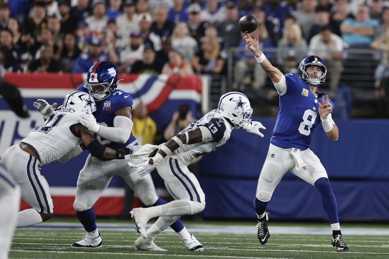 New York Giants quarterback Daniel Jones (8) passes against the Dallas Cowboys during the first half of an NFL football game, Thursday, Sept. 26, 2024, in East Rutherford, N.J. (AP Photo/Adam Hunger)