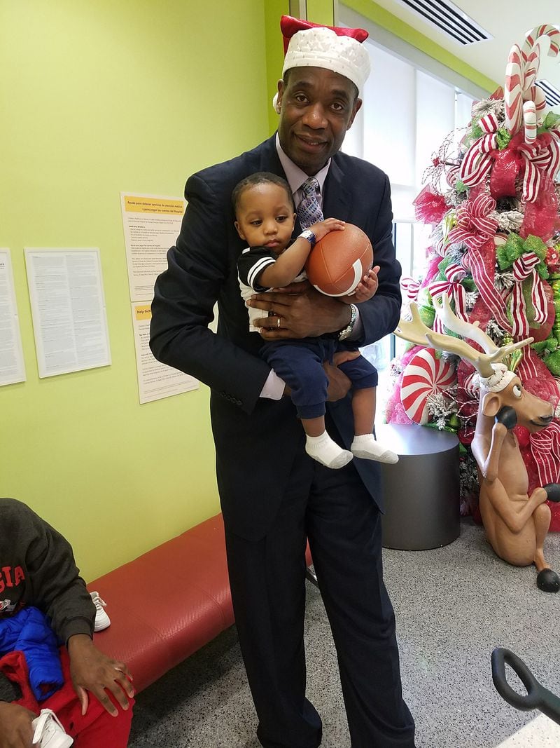 Mutombo with patients at Hughes Spalding Children's Hospital. CONTRIBUTED BY: Dikembe Mutombo Foundation