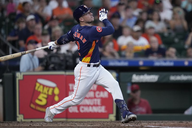 Houston Astros' Alex Bregman hits an RBI sacrifice fly during the third inning of a baseball game against the Los Angeles Angels, Sunday, Sept. 22, 2024, in Houston. (AP Photo/Kevin M. Cox)