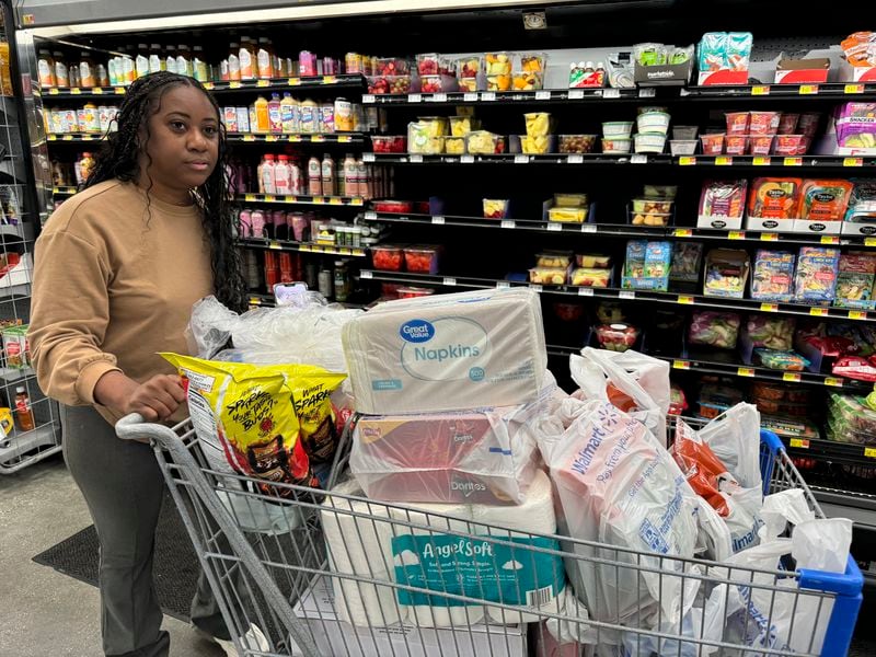 Roxanne Riley, 42, stocks up on supplies at a Walmart as she prepares to shelter in place in New Orleans as Tropical Storm Francine barrels toward the Louisiana coast, Tuesday, Sept. 10, 2024. (AP Photo/Jack Brook)