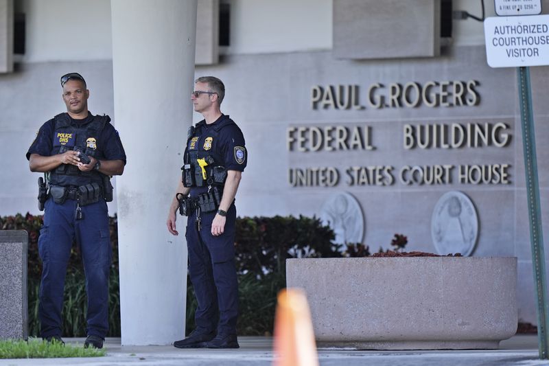 Department of Homeland Security officers patrol outside the Paul G. Rogers Federal Building and U.S. Courthouse, where a man suspected in an apparent assassination attempt targeting former President Donald Trump, was charged with federal gun crimes, Monday, Sept. 16, 2024, in West Palm Beach, Fla. (AP Photo/Wilfredo Lee)