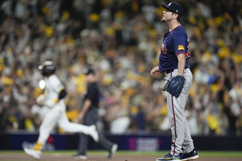 Atlanta Braves pitcher Luke Jackson stands on the mound after giving up a solo home run to San Diego Padres' Kyle Higashioka during the eighth inning in Game 1 of an NL Wild Card Series baseball game Tuesday, Oct. 1, 2024, in San Diego. (AP Photo/Gregory Bull)