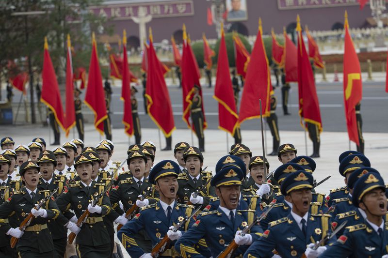 Honour guard members parade during a welcome ceremony for Vietnam's President To Lam at the Great Hall of the People in Beijing Monday, Aug. 19, 2024. (Andres Martinez Casares/Pool Photo via AP)