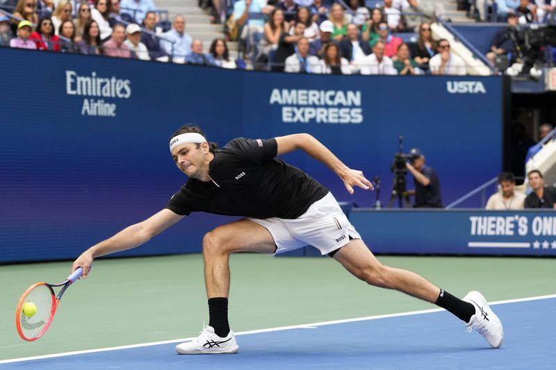 Taylor Fritz, of the United States, returns a shot to Jannik Sinner, of Italy, during the men's singles final of the U.S. Open tennis championships, Sunday, Sept. 8, 2024, in New York. (AP Photo/Kirsty Wigglesworth)