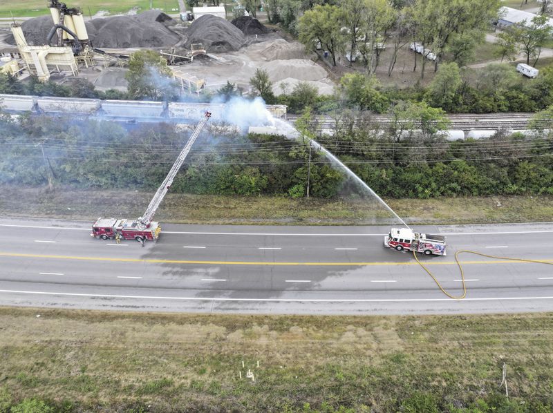 Firefighters work on the scene of a chemical leak in railcars near Cleves, Ohio, Tuesday, Sept. 24, 2024. (Local 12/WKRC via AP)