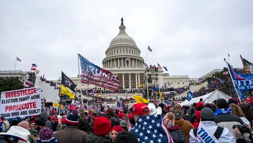 FILE - Rioters loyal to President Donald Trump rally at the U.S. Capitol in Washington, Jan. 6, 2021. Retired NASCAR driver Tighe Scott, his adult son and two other Pennsylvania men are facing felony charges stemming from confrontations with police during the Jan. 6, 2021, siege on the U.S. Capitol. (AP Photo/Jose Luis Magana, File)