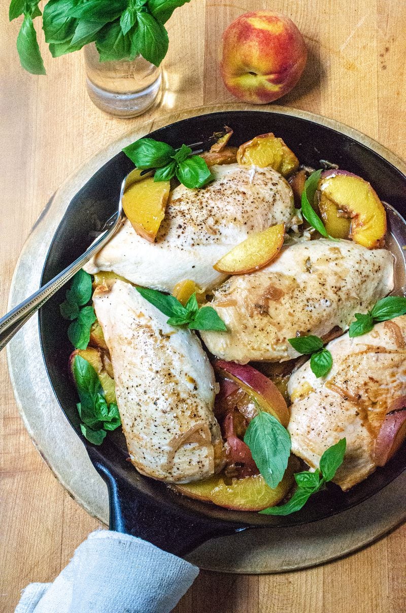 Each serving of Baked Chicken with Peaches and Basil contains an entire peach per person. (Virginia Willis for The Atlanta Journal-Constitution)