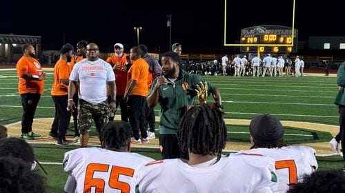 Stockbridge coach Kendrick Callier (center) talks to his players after their 14-10 win over Ola, Oct. 4, 2024