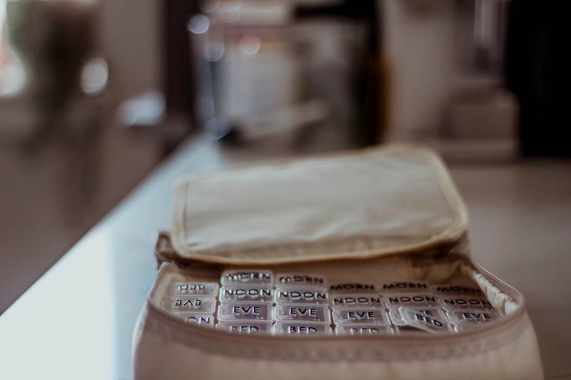 
                        A pill organizer kept by Amina AlTai, who said she had to re-evaluate the stressors in her life after being diagnosed with two chronic diseases, at her home in Brooklyn on June 14, 2024. Chronic disease symptoms are often dismissed by physicians — and patients themselves. But that comes from a complex relationship between sickness and stress itself. (Laila Stevens/The New York Times)
                      