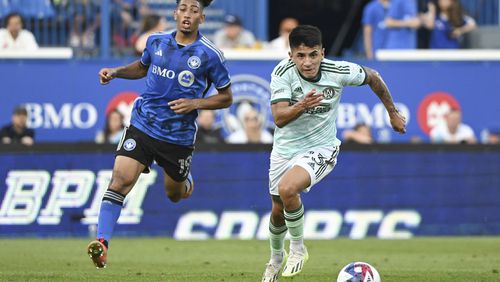 Atlanta United's Thiago Almada (23) breaks away from CF Montreal's Nathan-Dylan Saliba (19) during the first half of an MLS soccer match Saturday, July 8, 2023, in Vancouver, British Columbia. (Graham Hughes/The Canadian Press via AP)