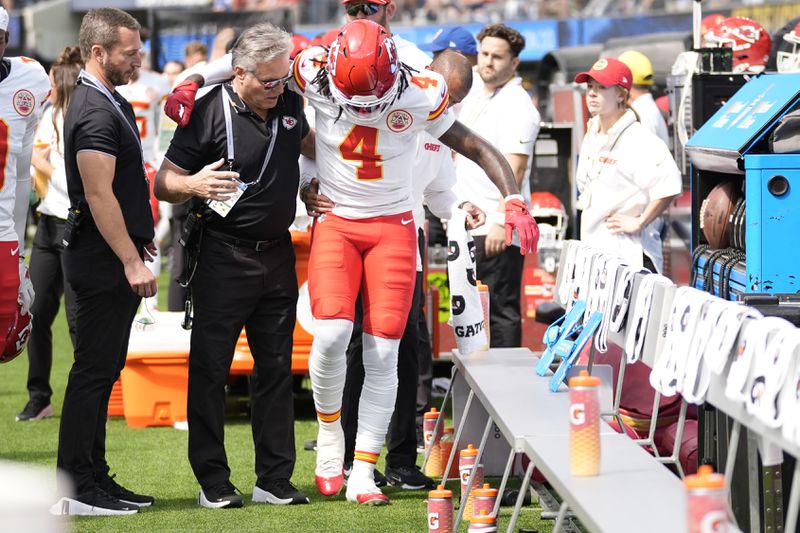 Kansas City Chiefs wide receiver Rashee Rice (4) is assisted after being injured during the first half of an NFL football game against the Los Angeles Chargers Sunday, Sept. 29, 2024, in Inglewood, Calif. (AP Photo/Ashley Landis)