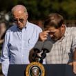 President Joe Biden (left) visited South Georgia to survey damage from Hurricane Helene on Thursday. He said the federal government was working to meet the needs of families and businesses affected by the storm, which tore a path through the Southeast roughly a week ago. He bows his head as pecan farmer Buck Paulk says a prayer at his farm in Ray City on Thursday, Oct. 3, 2024. (Arvin Temkar/AJC)