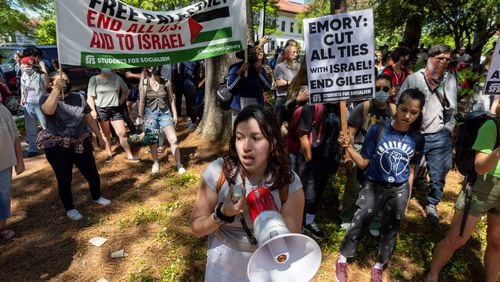 Pro-Palestinian protesters chant at police at the Emory campus in Atlanta following arrests on Thursday, April 25, 2024. (Arvin Temkar / AJC)