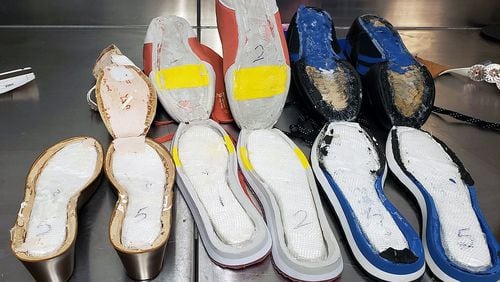 Customs officials said they found $40,000 worth of cocaine hidden in seven pairs of the woman's shoes.