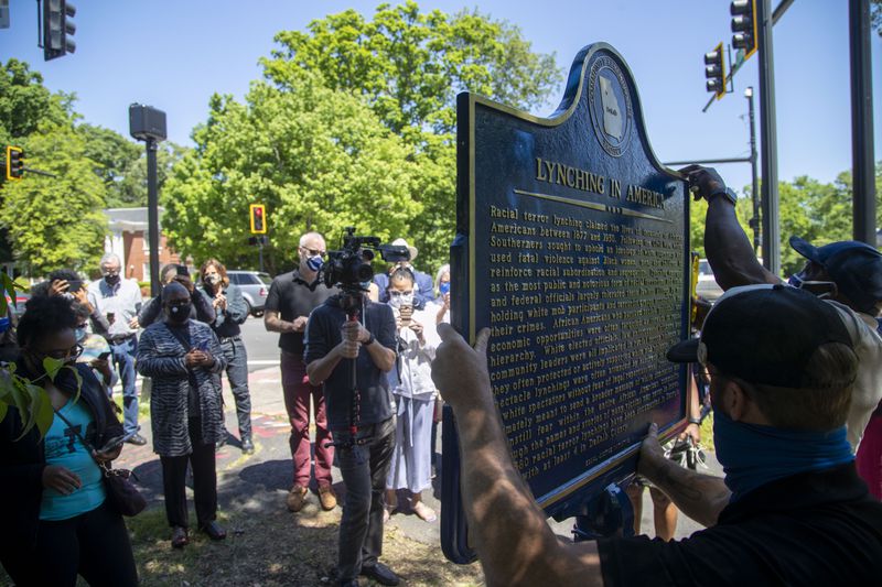 05/06/2021 — Atlanta, Georgia — People gather to watch the installation of a historical marker that tells the story of the lynching of Porter Flournoy Turner at the intersection of Ponce De Leon Ave NE and Oakdale Road NE in Atlanta’s Druid Hills community, Thursday, May 6, 2021. Porter Turner was lynched near the area in August 1945. (Alyssa Pointer / Alyssa.Pointer@ajc.com)