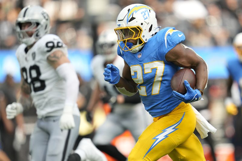 Los Angeles Chargers running back J.K. Dobbins (27) runs against the Las Vegas Raiders during the second half of an NFL football game, Sunday, Sept. 8, 2024, in Inglewood, Calif. (AP Photo/Ashley Landis)