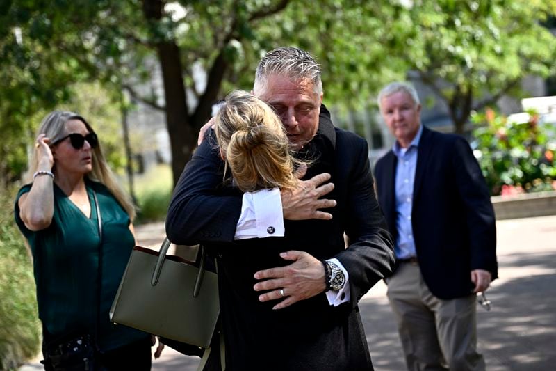 Former vice-admiral Haydn Edmundson embraces a family member after being found not guilty of sexual assault and an indecent act, Monday, Sept. 16, 2024, in Ottawa. (Justin Tang/The Canadian Press via AP)