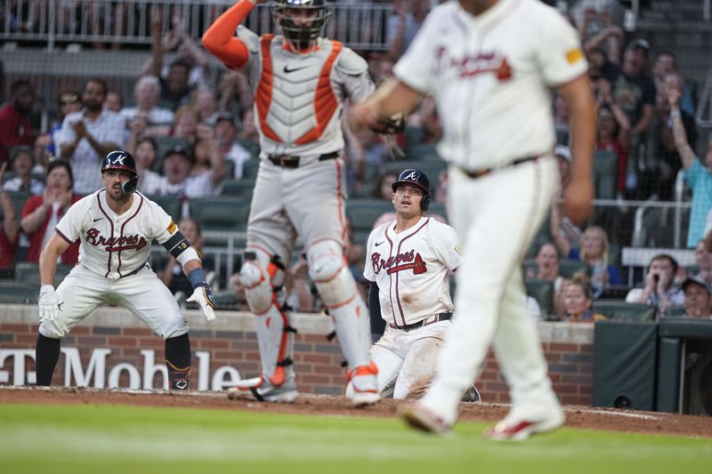 Atlanta Braves' Austin Riley (27) looks back after getting tagged out by San Francisco Giants catcher Curt Casali (18) in the fifth inning of a baseball game, Wednesday, July 3, 2024, in Atlanta. (AP Photo/Brynn Anderson)