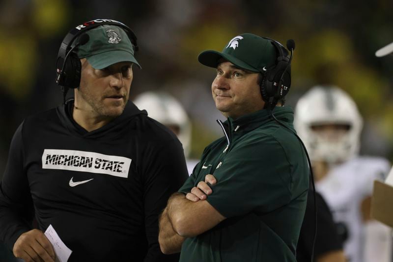 Michigan State head coach Jonathan Smith, right, reacts during the first half of an NCAA college football game against Oregon, Friday, Oct. 4, 2024, in Eugene, Ore. (AP Photo/Amanda Loman)