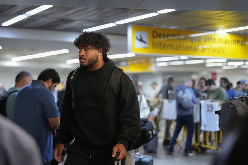 The Green Bay Packers' Jordan Morgan arrives at Sao Paulo International airport ahead of a game against the Philadelphia Eagles, in Guarulhos, greater Sao Paulo, Brazil, Wednesday, Sept. 4, 2024. (AP Photo/Andre Penner)