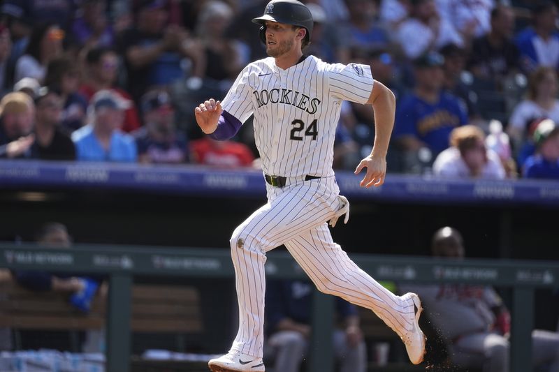 Colorado Rockies' Ryan McMahon scores on a double hit by Brendan Rodgers off Atlanta Braves relief pitcher Joe Jiménez in the eighth inning of a baseball game, Sunday, Aug. 11, 2024, in Denver. (AP Photo/David Zalubowski)