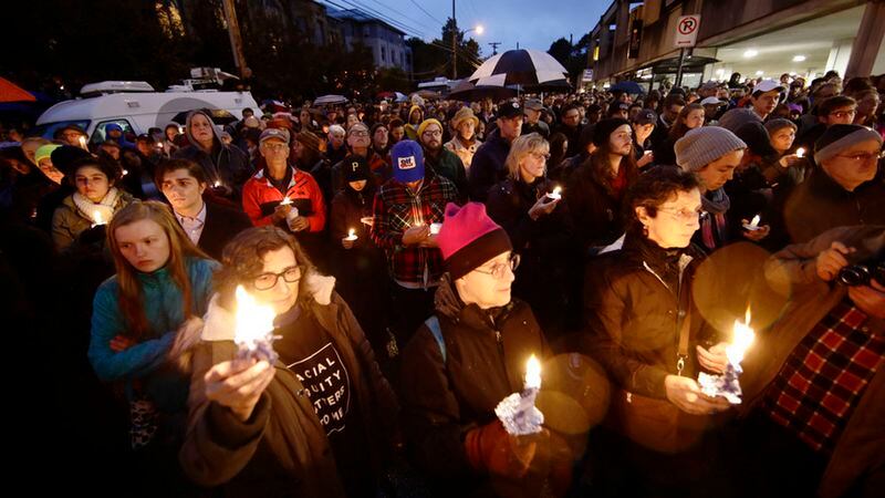 People hold candles as they gather for a vigil in the aftermath of a deadly shooting at the Tree of Life Congregation, in the Squirrel Hill neighborhood of Pittsburgh, Saturday, Oct. 27, 2018. (AP Photo/Matt Rourke)