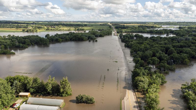 Highway 11 is submerged Saturday, June 22, 2024, in south of Brandon, S.D., after days of heavy rain led to flooding in the area. (AP Photo/Josh Jurgens)