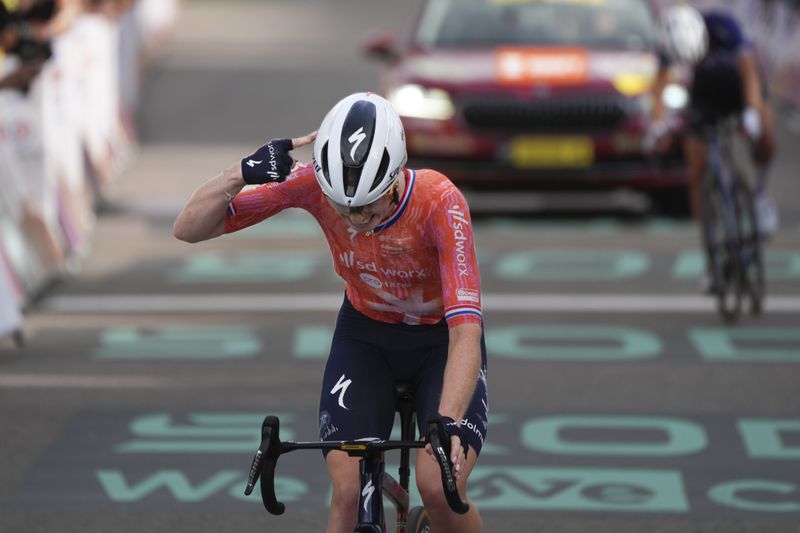 Demi Vollering of The Netherlands crosses the finish line to win the eighth stage of the Tour de France Women cycling race with start in Le Grand-Bornand and finish in Alpe d'Huez, France, Sunday, Aug. 18, 2024. (AP Photo/Peter Dejong)