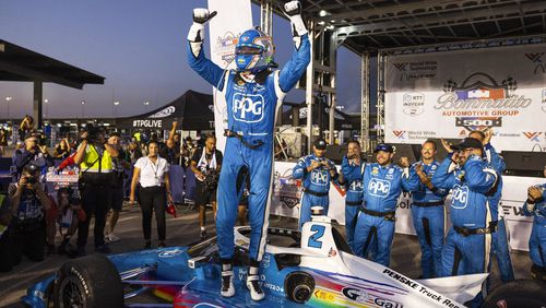 Josef Newgarden celebrates on top of his car after winning an IndyCar race on Saturday, Aug. 17, 2024, at World Wide Technology Raceway in Madison, Ill. (Zachary Linhares/St. Louis Post-Dispatch via AP)