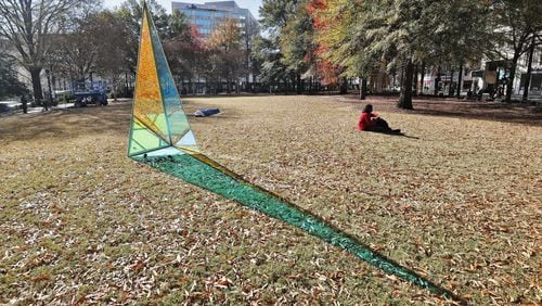 This light-shifting sculpture by David Baerwalde and Alex Martinez is part of the public art installation “PRISM: Winter Lights at Woodruff Park.”   The exhibit spreads throughout the downtown park, enhancing existing landmarks like the International Peace Fountain and the iconic gazebo with geometric sculptures, "upcycled" lights, and a light garden.  Bob Andres / bandres@ajc.com