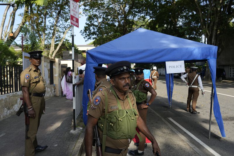 Police officers wait for transport to travel to polling stations ahead of the upcoming presidential election, in Colombo, Sri Lanka, Friday, Sept. 20, 2024. (AP Photo/Eranga Jayawardena)