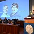 Nobel Committee chairman Thomas Perlmann, right, announces Americans Victor Ambros, left, and Gary Ruvkun, seen on a screen being awarded this year's Nobel Prize in Physiology or Medicine, during a press conference at the Karolinska Institute in Stockholm, Sweden, on Monday, Oct. 7, 2024. (Christine Olsson/TT News Agency via AP)