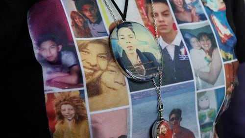 Photos of Veronica Rosas and her son Diego decorate Veronica's shirt and necklaces, as she poses for a portrait at her home in Ecatepec, Mexico, Friday, Aug. 2, 2024. Rosas' son went missing when he was 16 years old on Sept. 4, 2015. (AP Photo/Ginnette Riquelme)