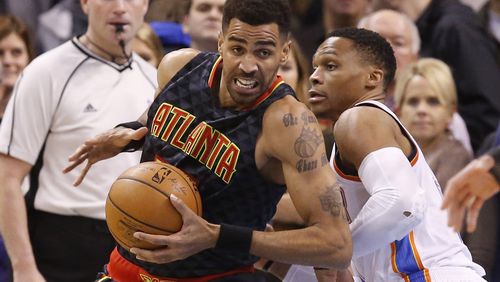 Atlanta Hawks forward Thabo Sefolosha, left, drives around Oklahoma City Thunder guard Russell Westbrook, right, in the first half of an NBA basketball game in Oklahoma City, Monday, Dec. 19, 2016. (AP Photo/Sue Ogrocki)