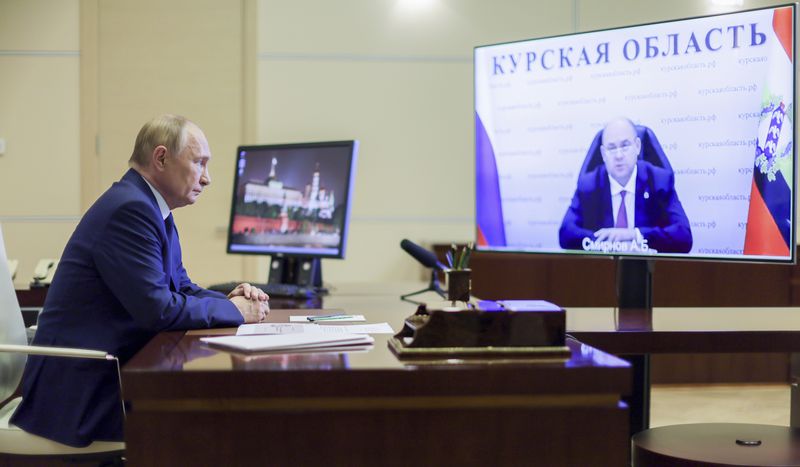 FILE - Russian President Vladimir Putin, left, listens to acting Gov. Alexei Smirnov of the Kursk region during a videoconference at Putin’s Novo-Ogaryovo state residence outside Moscow, Russia, on Aug. 8, 2024. (Gavriil Grigorov, Sputnik, Kremlin Pool Photo via AP, File)