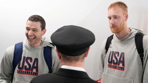 Team USA basketball athletes, Mitch Hahn, right, and Jimmer Fredette, talk with people before departing for the Paris Summer Olympic games, on Wednesday, July 17, 2024, in Atlanta. (AP Photo/Brynn Anderson)