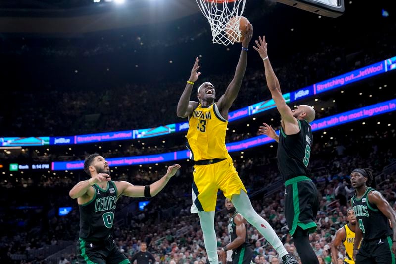 Indiana Pacers forward Pascal Siakam (43) drives to the basket between Boston Celtics forward Jayson Tatum (0) and guard Derrick White (9) during the first half of Game 2 of the NBA Eastern Conference basketball finals Thursday, May 23, 2024, in Boston. (AP Photo/Steven Senne)