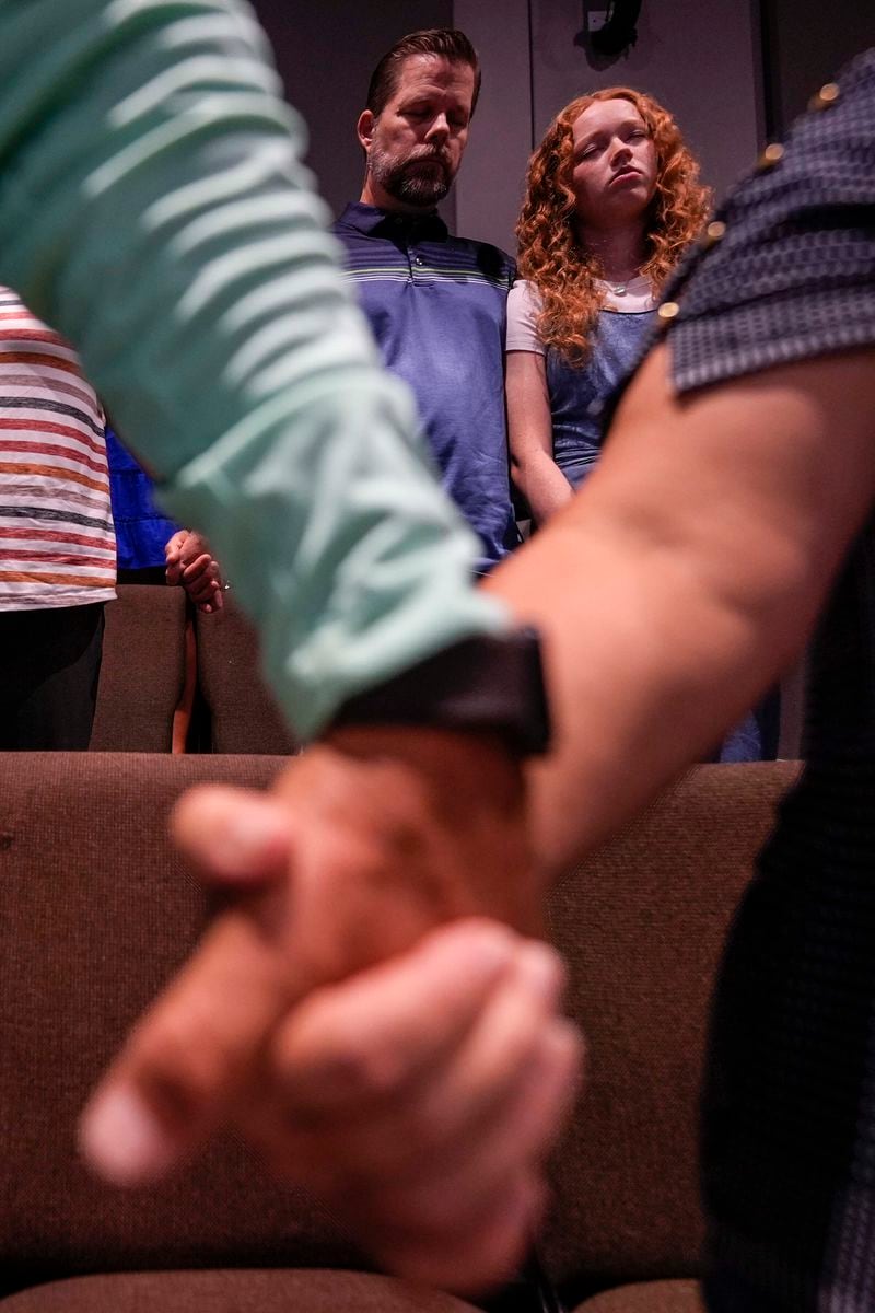 Church members pray during a Sunday service at Bethlehem Church, Sunday, Sept. 8, 2024, in Bethlehem, Ga. Colt Gray, 14, has been charged with murder over the killing of two students and two teachers at Apalachee High School in Barrow County, outside Atlanta, on Wednesday. (AP Photo/Mike Stewart)