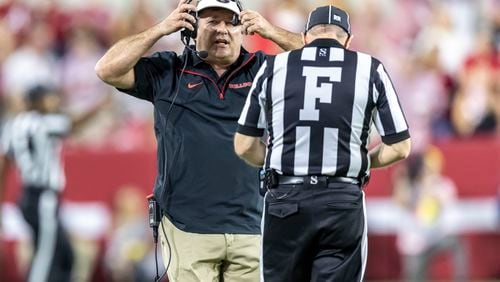 Georgia head coach Kirby Smart runs to a referee to discuss a call during the first half of an NCAA college football game against Alabama, Saturday, Sept. 28, 2024, in Tuscaloosa, Ala. (AP Photo/Vasha Hunt)