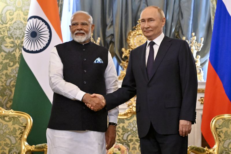 Russian President Vladimir Putin and Indian Prime Minister Narendra Modi shake hands during a meeting at the Kremlin in Moscow, Russia, Tuesday, July 9, 2024. (Alexander Nemenov/Pool Photo via AP)