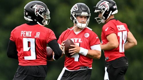 Atlanta Falcons quarterbacks (from left)  Michael Penix Jr. (9), Taylor Heinicke (4) and Kirk Cousins (18) practice during day 1 of Atlanta Falcons Training Camp on Thursday, July 25, 2024 in Flowery Branch. (Hyosub Shin / AJC)