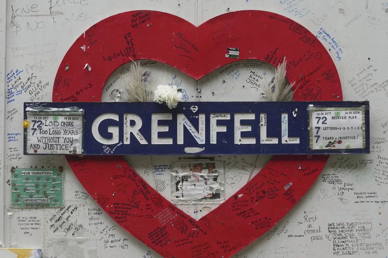 A view of the memorial wall by Grenfell Tower after a fire in June, 2017, in London, Monday, Sept. 2, 2024, in which 72 people were killed. (AP Photo/Kin Cheung)