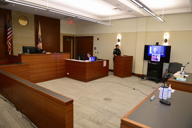 Sean M. Higgins, right, the alleged drunken driver charged with killing NHL hockey player Johnny Gaudreau and his brother Matthew as they bicycled on a rural road, appears before Judge Michael Silvanio, left, for his hearing via video from jail, Friday, Sept. 13, 2024, in Woodbury, N.J. (AP Photo/Derik Hamilton)