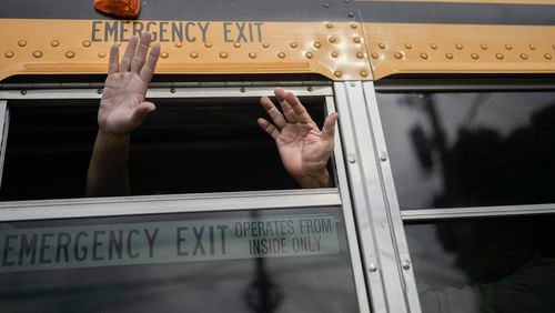 Nicaraguan citizens wave from a bus after being released from a Nicaraguan jail and landing at the airport in Guatemala City, Thursday, Sept. 5, 2024. (AP Photo/Moises Castillo)