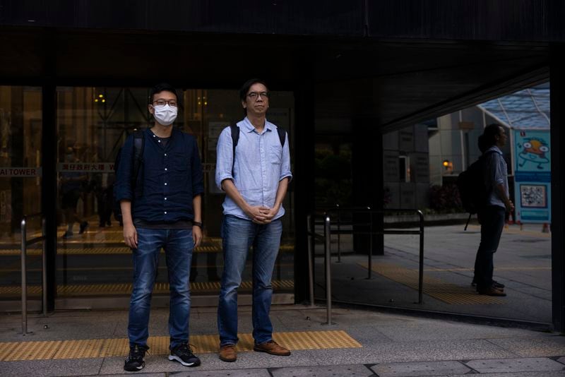 FILE - Former chief editor Chung Pui-kuen, right, and former acting editor Patrick Lam, left, of the now-defunct independent media outlet Stand News leave the court on the last day of the publication's sedition trial closing statements in Hong Kong, June 28, 2023. (AP Photo/Louise Delmotte, File)