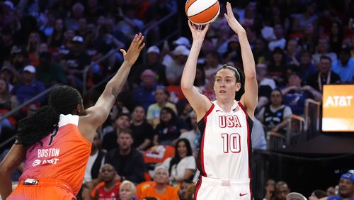 Breanna Stewart (10), of Team USA, looks to shoot a 3-point basket over Aliyah Boston, of Team WNBA, during the first half of a WNBA All-Star basketball game Saturday, July 20, 2024, in Phoenix. (AP Photo/Ross D. Franklin)