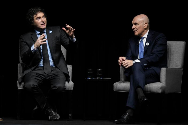 Argentine President Javier Milei, left, addresses the crowd at a promotional event for his new book, alongside National Deputy Jose Luis Espert in Buenos Aires, Argentina, Wednesday, May 22, 2024. (AP Photo/Gustavo Garello)