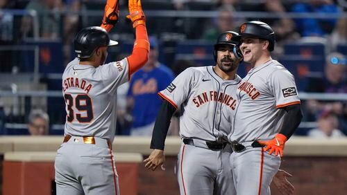 San Francisco Giants' Patrick Bailey, right, celebrates with LaMonte Wade Jr., center, and Thairo Estrada after hitting a grand slam against the New York Mets during the eighth inning of a baseball game Friday, May 24, 2024, in New York. (AP Photo/Frank Franklin II)